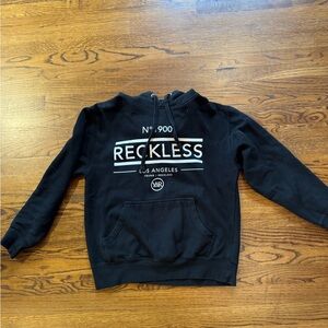 Size medium black young & reckless hoodie.
